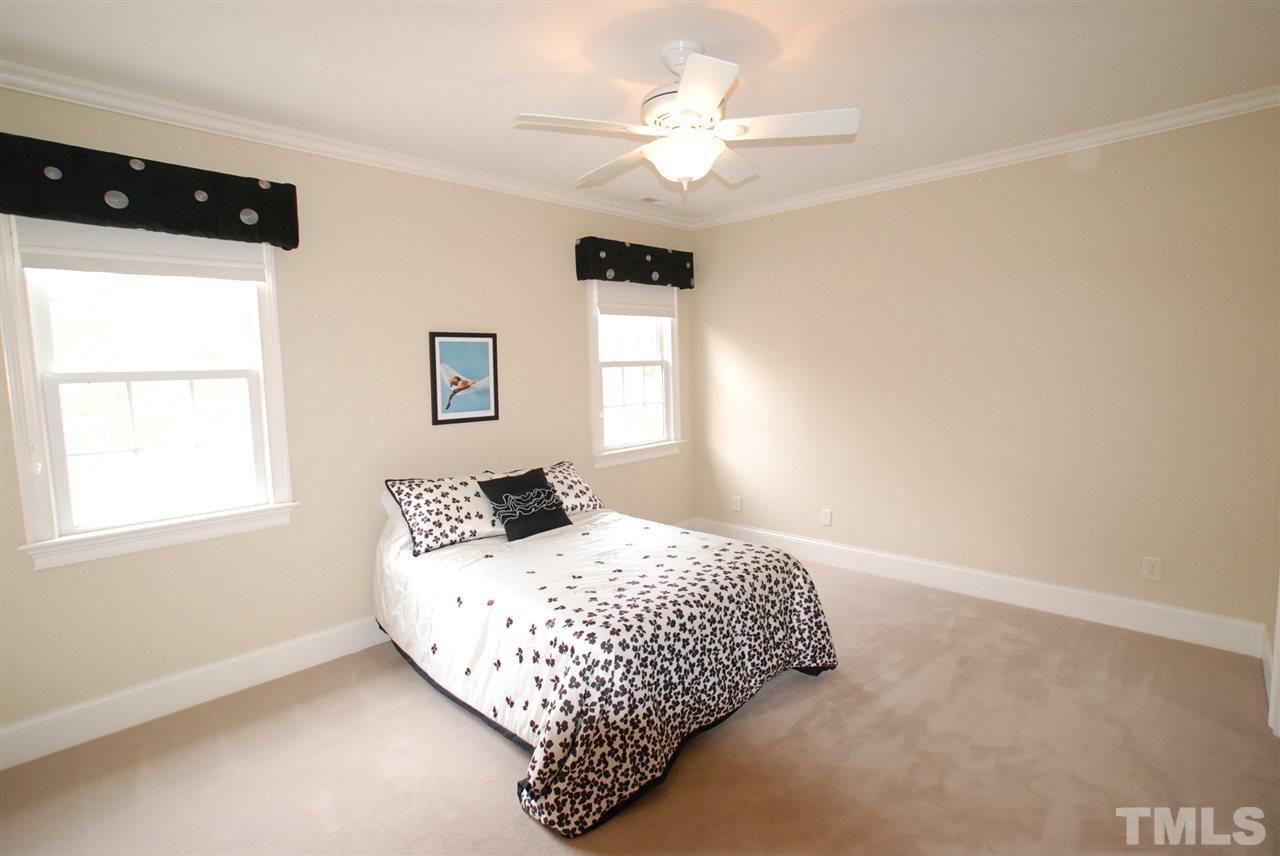 1093 Tacketts Pond Drive Raleigh, NC 27614 - Photo 13 of 25 a bedroom with a large bed and a window