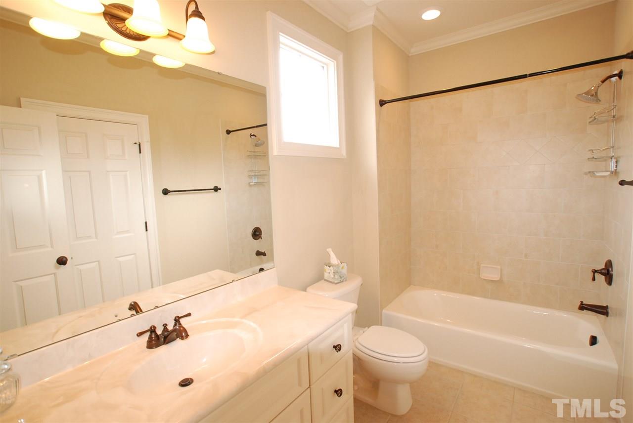 1093 Tacketts Pond Drive Raleigh, NC 27614 - Photo 14 of 25 a bathroom with a sink a toilet and shower