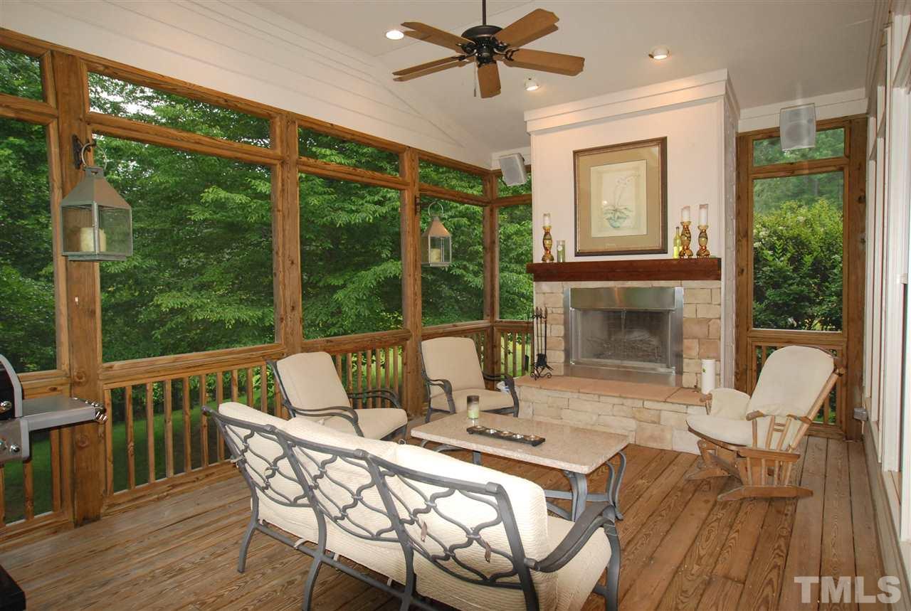 1093 Tacketts Pond Drive Raleigh, NC 27614 - Photo 21 of 25 a view of a patio with a fireplace dining table and chairs
