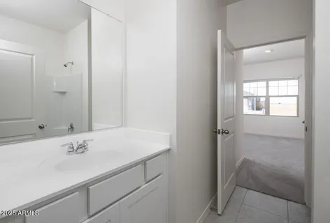 a bedroom with a bed and a night stand