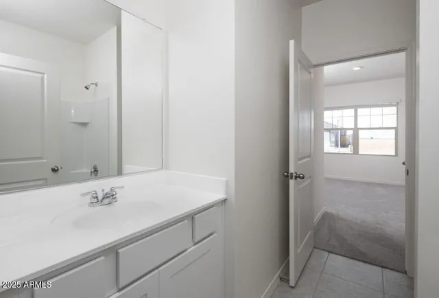 a bedroom with a bed and a night stand