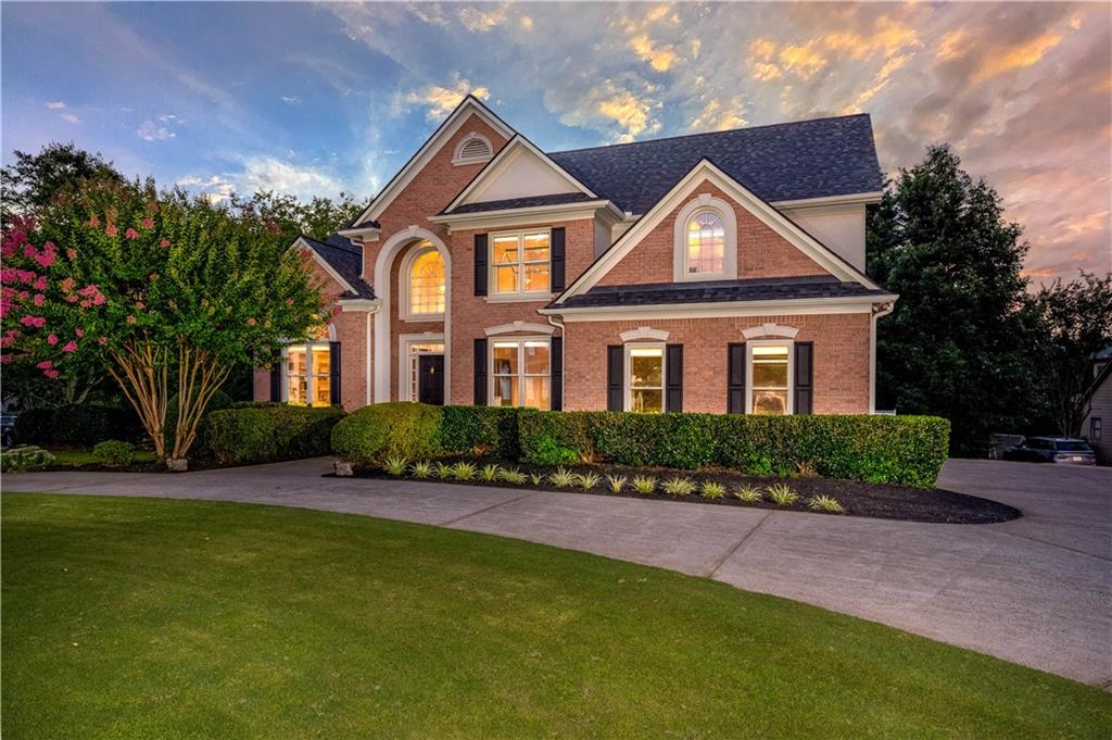 a front view of a house with a yard