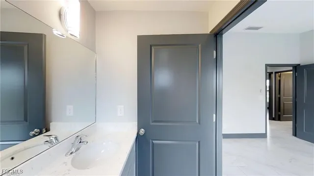 a bathroom with a sink and a mirror