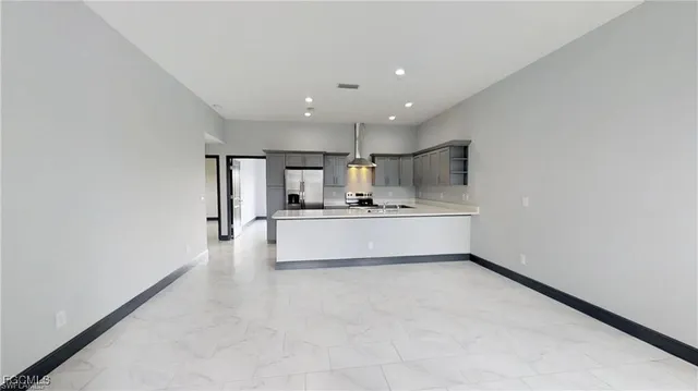 a view of kitchen with refrigerator sink and cabinets