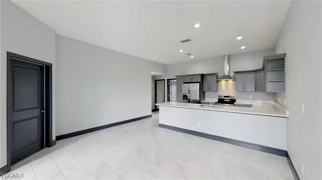 a kitchen with stainless steel appliances a sink stove and refrigerator