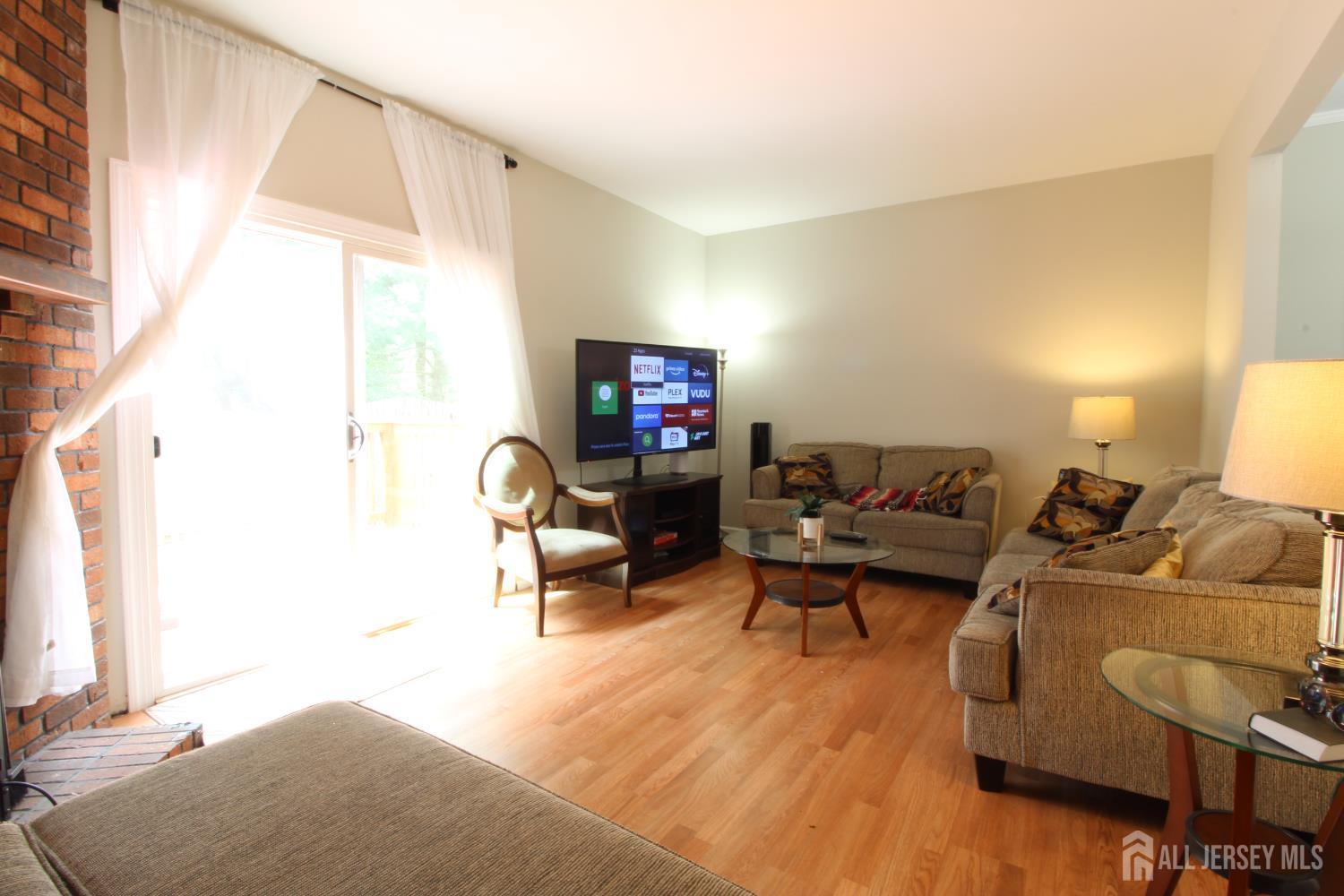 41 Brookview Circle Jamesburg, NJ 08831 - Photo 13 of 38 a living room with furniture and a window
