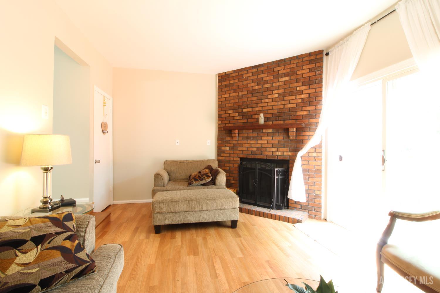 41 Brookview Circle Jamesburg, NJ 08831 - Photo 14 of 38 a living room with furniture and a fireplace