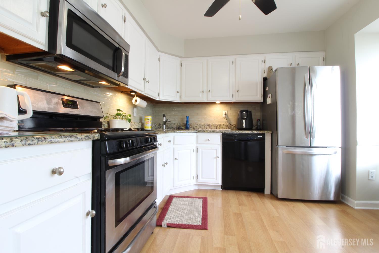41 Brookview Circle Jamesburg, NJ 08831 - Photo 2 of 38 a kitchen with stainless steel appliances a refrigerator stove and microwave