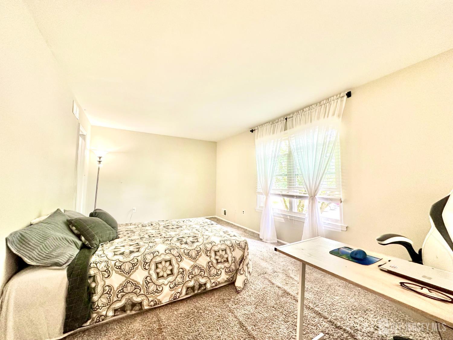 41 Brookview Circle Jamesburg, NJ 08831 - Photo 21 of 38 a bedroom with a bed and a window