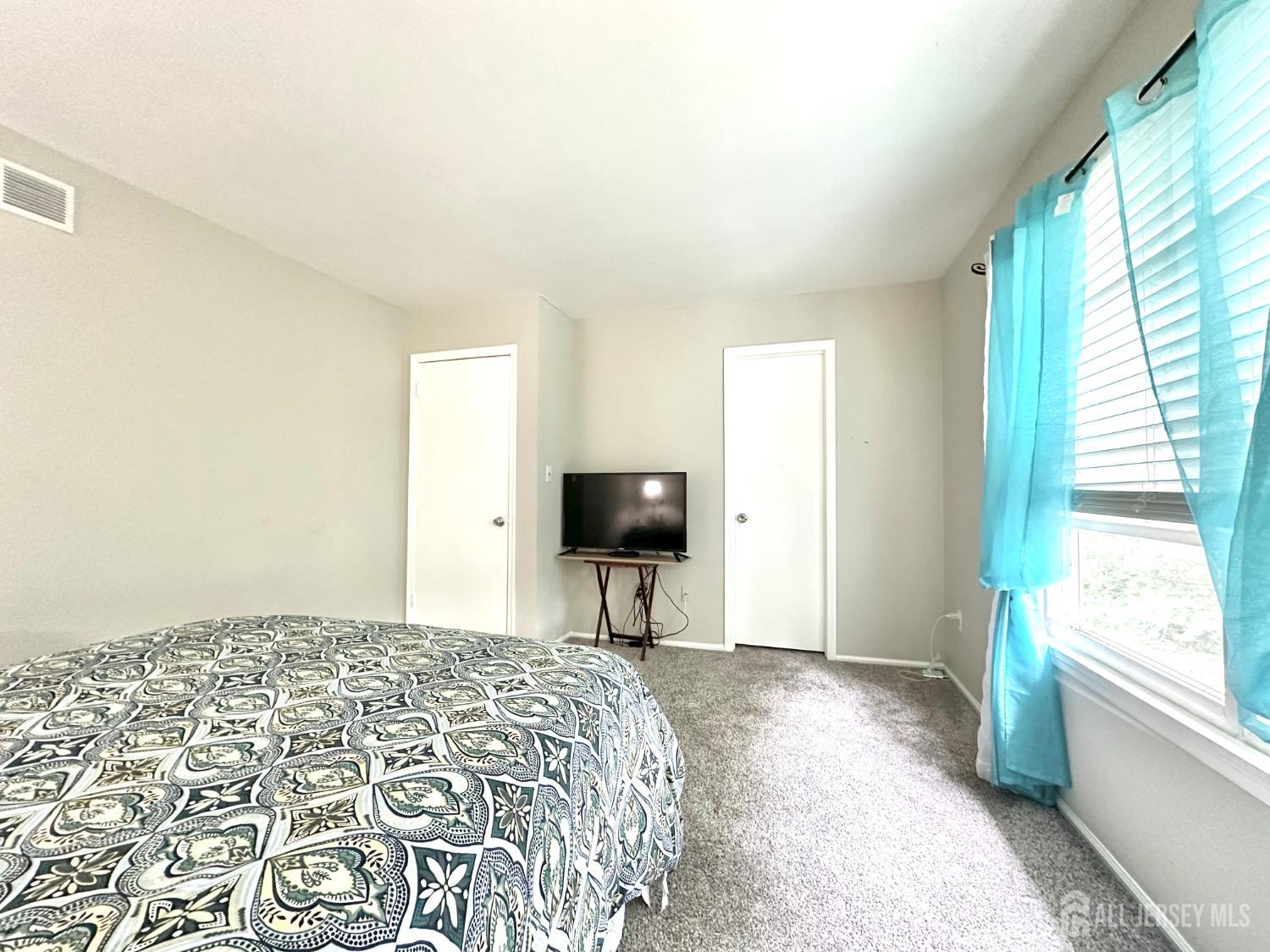 41 Brookview Circle Jamesburg, NJ 08831 - Photo 31 of 38 a bedroom with a bed and a chandelier