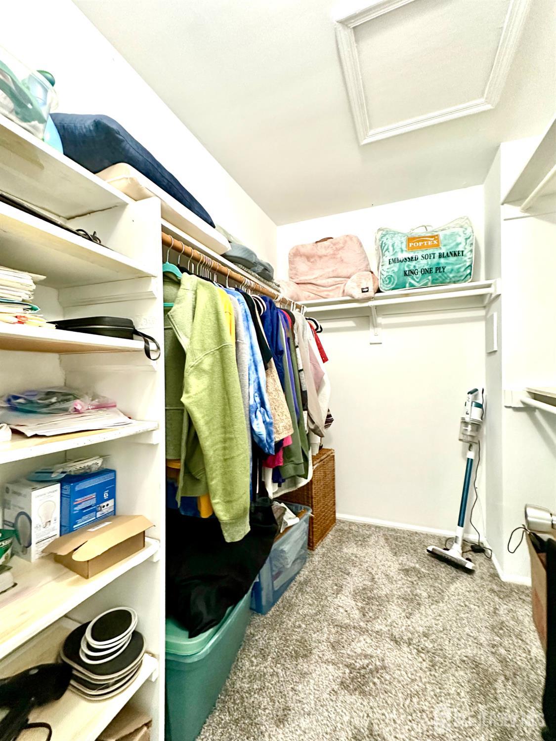 41 Brookview Circle Jamesburg, NJ 08831 - Photo 32 of 38 a view of walk in closet with clothes and shoes