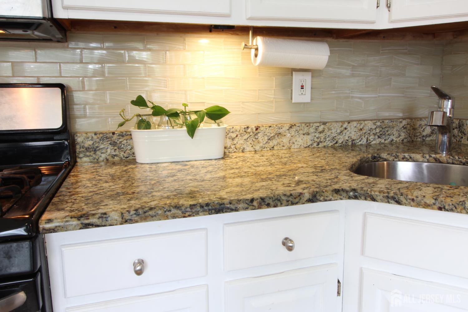 41 Brookview Circle Jamesburg, NJ 08831 - Photo 4 of 38 a kitchen with granite countertop white cabinets and a sink