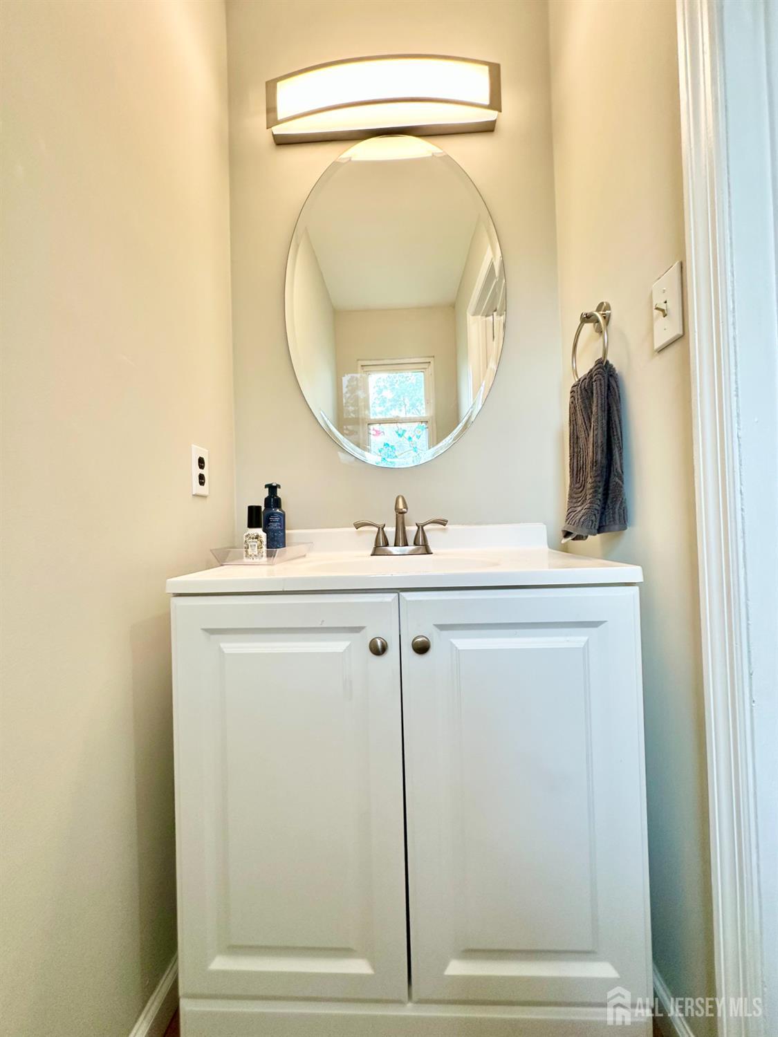 41 Brookview Circle Jamesburg, NJ 08831 - Photo 7 of 38 a bathroom with a sink mirror and vanity