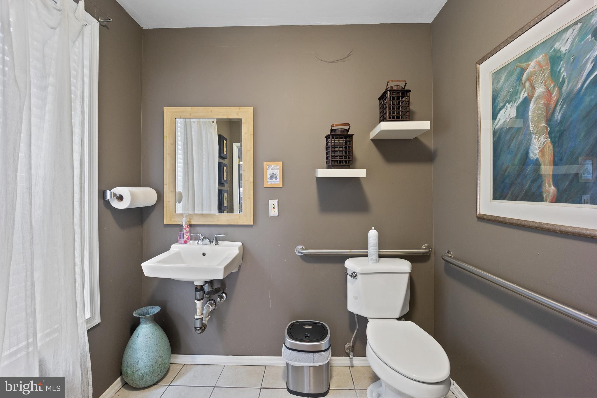 117 Haddon Avenue Haddon Township, NJ 08108 - Photo 10 of 30 a bathroom with a toilet sink and mirror