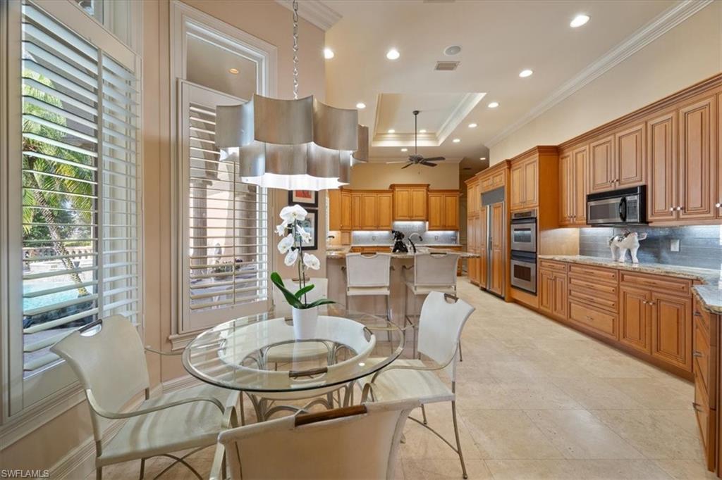 550 21st Avenue South Naples, FL 34102 - Photo 13 of 44 Dining room featuring ceiling fan, a raised ceiling, ornamental molding, visible vents, and recessed lighting