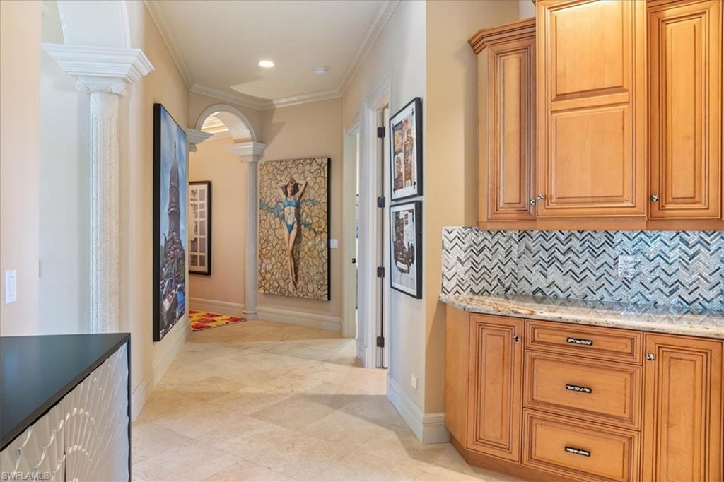 550 21st Avenue South Naples, FL 34102 - Photo 14 of 44 Corridor with light tile patterned flooring, decorative columns, baseboards, ornamental molding, and recessed lighting