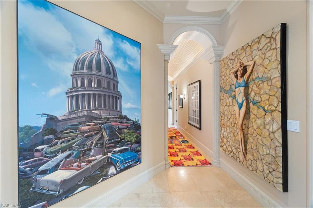 550 21st Avenue South Naples, FL 34102 - Photo 19 of 44 Corridor with tile patterned floors, baseboards, ornate columns, and crown molding