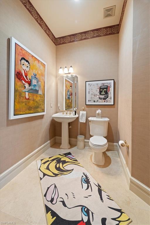 550 21st Avenue South Naples, FL 34102 - Photo 21 of 44 Half bath with visible vents, tile patterned flooring, baseboards, and toilet