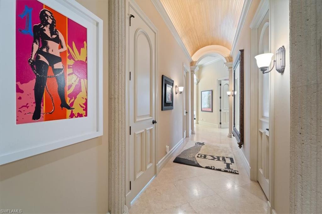 550 21st Avenue South Naples, FL 34102 - Photo 22 of 44 Corridor with decorative columns, lofted ceiling, tile patterned flooring, wood ceiling, and ornamental molding