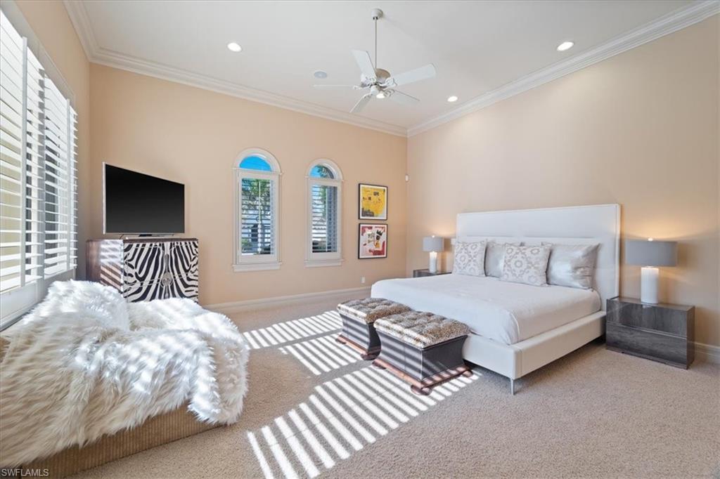 550 21st Avenue South Naples, FL 34102 - Photo 23 of 44 Bedroom featuring carpet, baseboards, and multiple windows