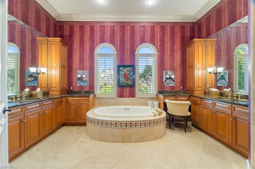 550 21st Avenue South Naples, FL 34102 - Photo 25 of 44 Full bathroom with a bath, vanity, and crown molding