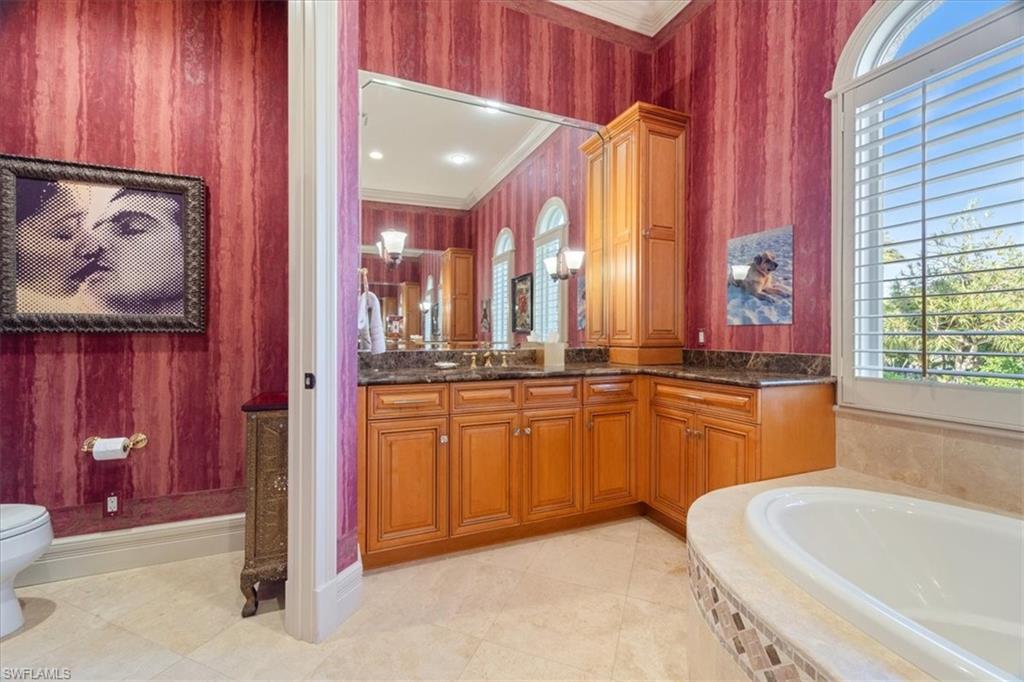 550 21st Avenue South Naples, FL 34102 - Photo 27 of 44 Full bath featuring a bath, toilet, crown molding, and vanity