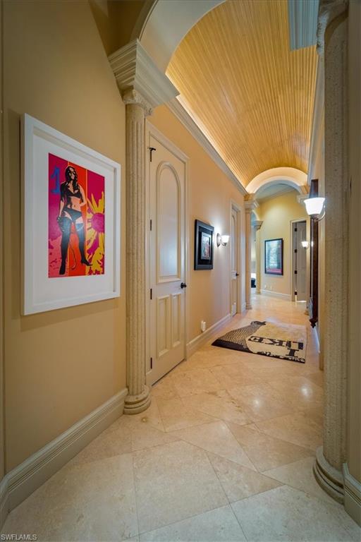 550 21st Avenue South Naples, FL 34102 - Photo 28 of 44 Hall with decorative columns, vaulted ceiling, wooden ceiling, and arched walkways