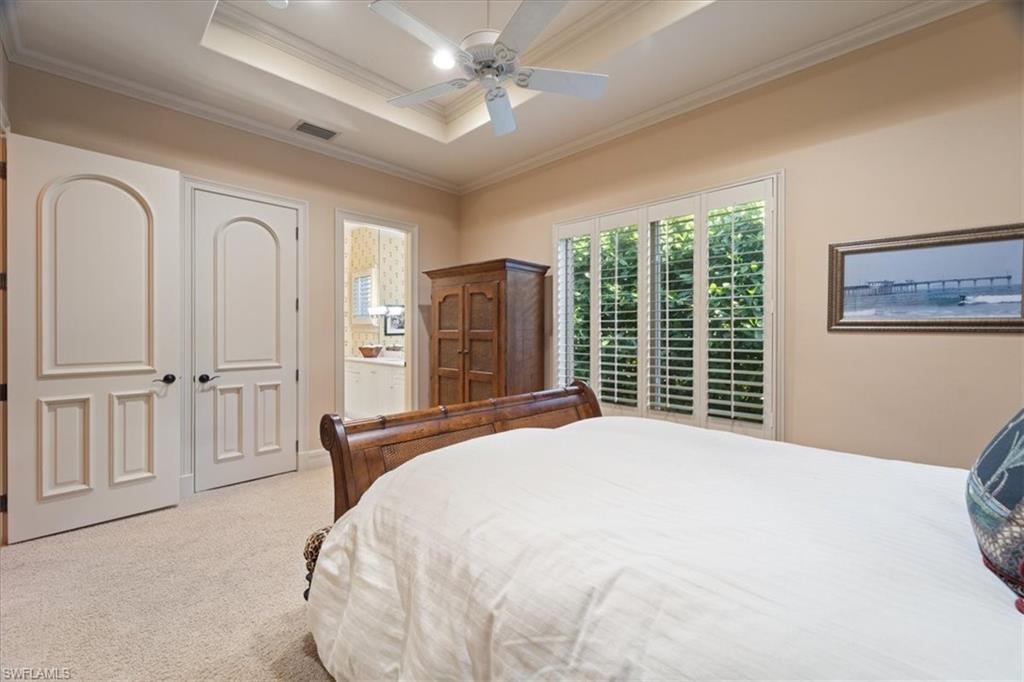 550 21st Avenue South Naples, FL 34102 - Photo 30 of 44 Bedroom with ensuite bathroom, visible vents, carpet, ceiling fan, and crown molding