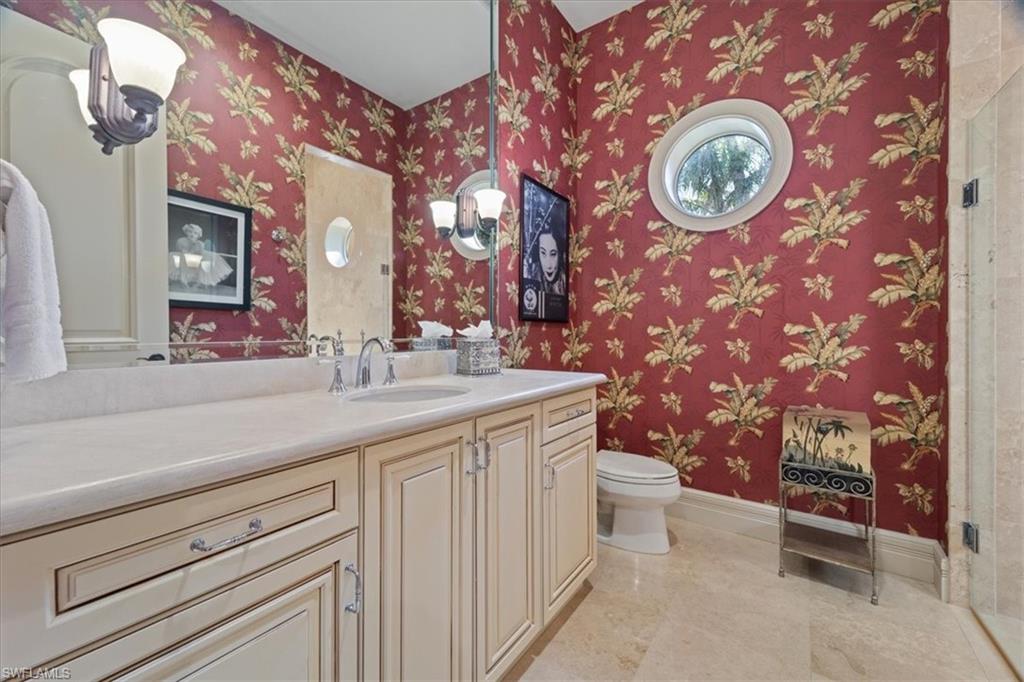 550 21st Avenue South Naples, FL 34102 - Photo 31 of 44 Bathroom with baseboards, vanity, marble finish floor, and toilet