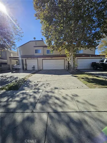 a house that has a tree in front of it