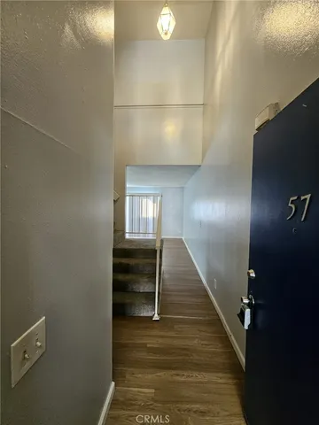 a view of entryway and hall with wooden floor