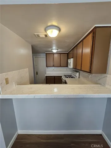 a view of living room with granite countertop furniture and wooden floor