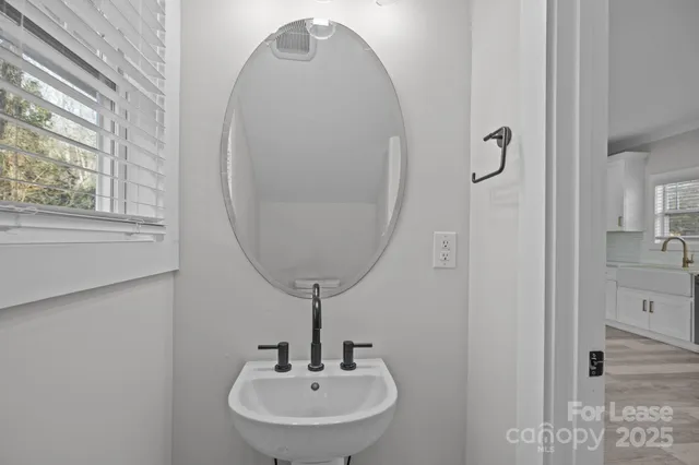 a bathroom with a sink and mirror