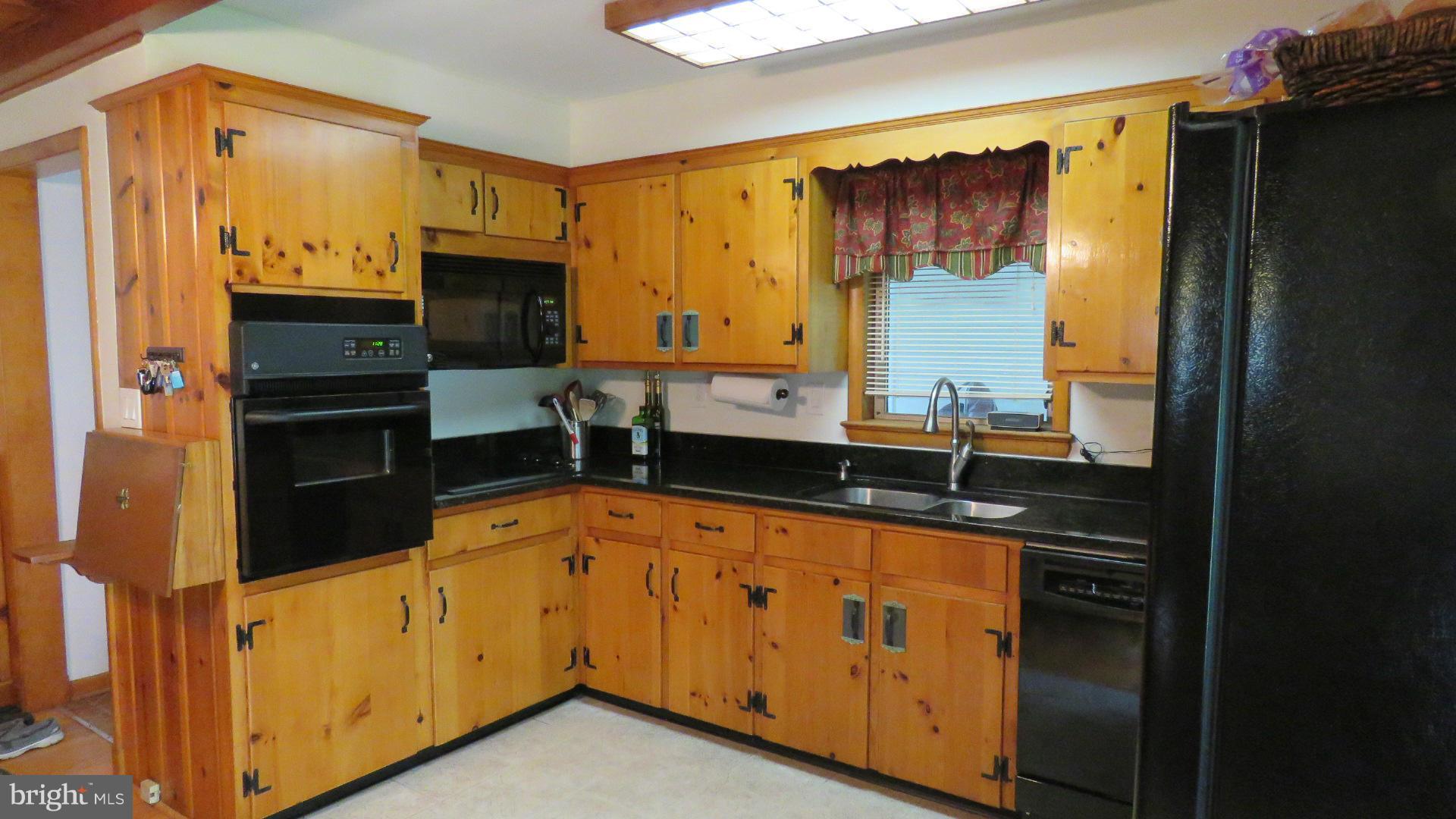 9813 Hawkins Creamery Road Damascus, MD 20872 - Photo 12 of 21 a kitchen with stainless steel appliances a sink cabinets and a refrigerator