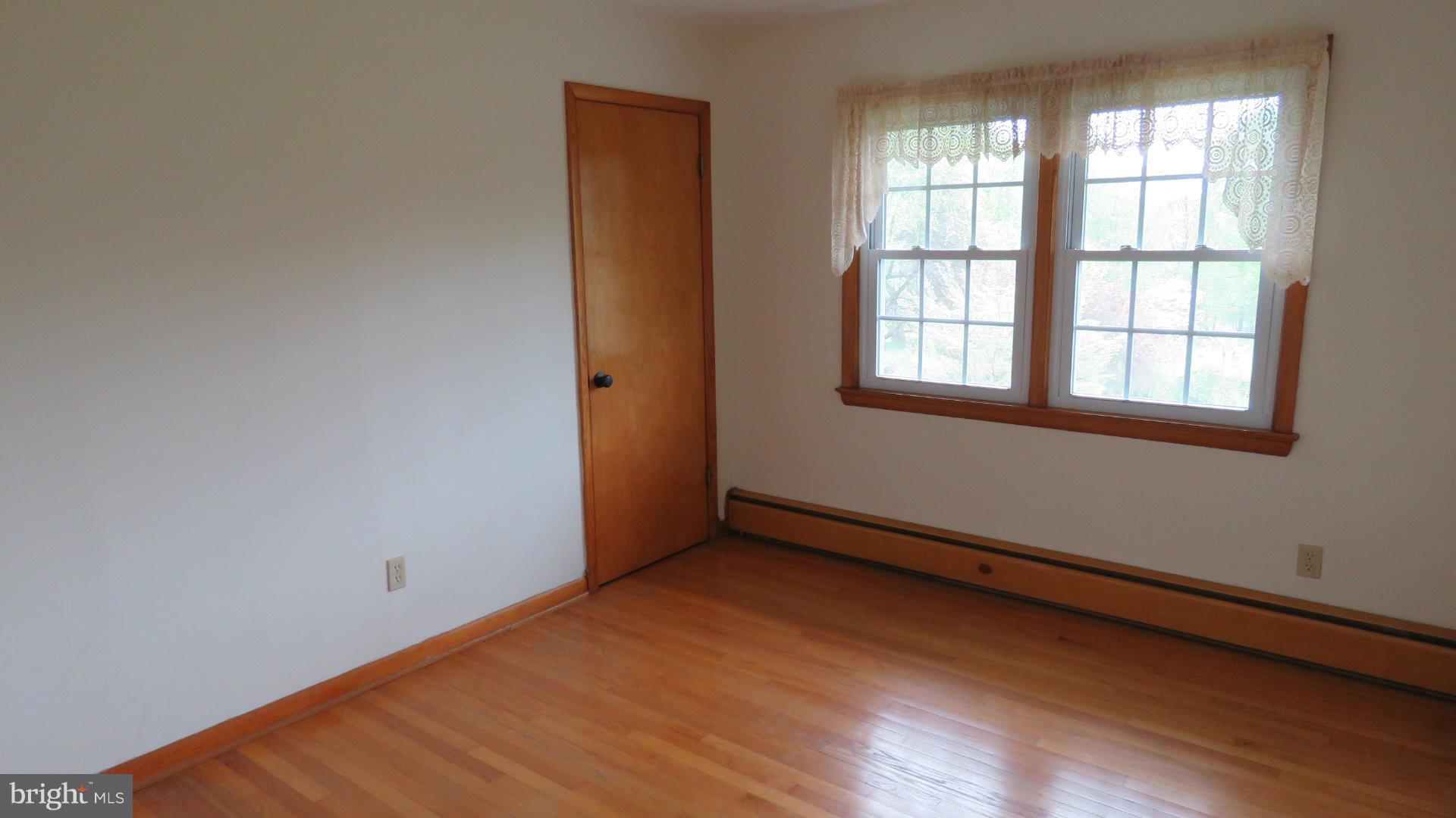 9813 Hawkins Creamery Road Damascus, MD 20872 - Photo 14 of 21 an empty room with wooden floor and windows