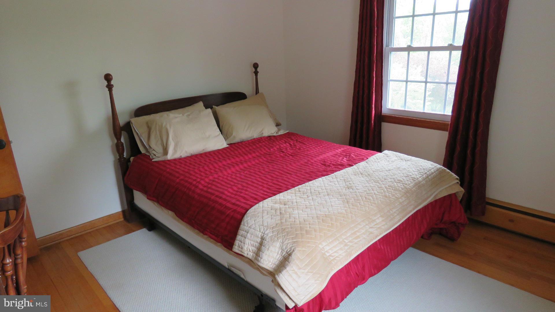 9813 Hawkins Creamery Road Damascus, MD 20872 - Photo 15 of 21 a bedroom with a bed and window