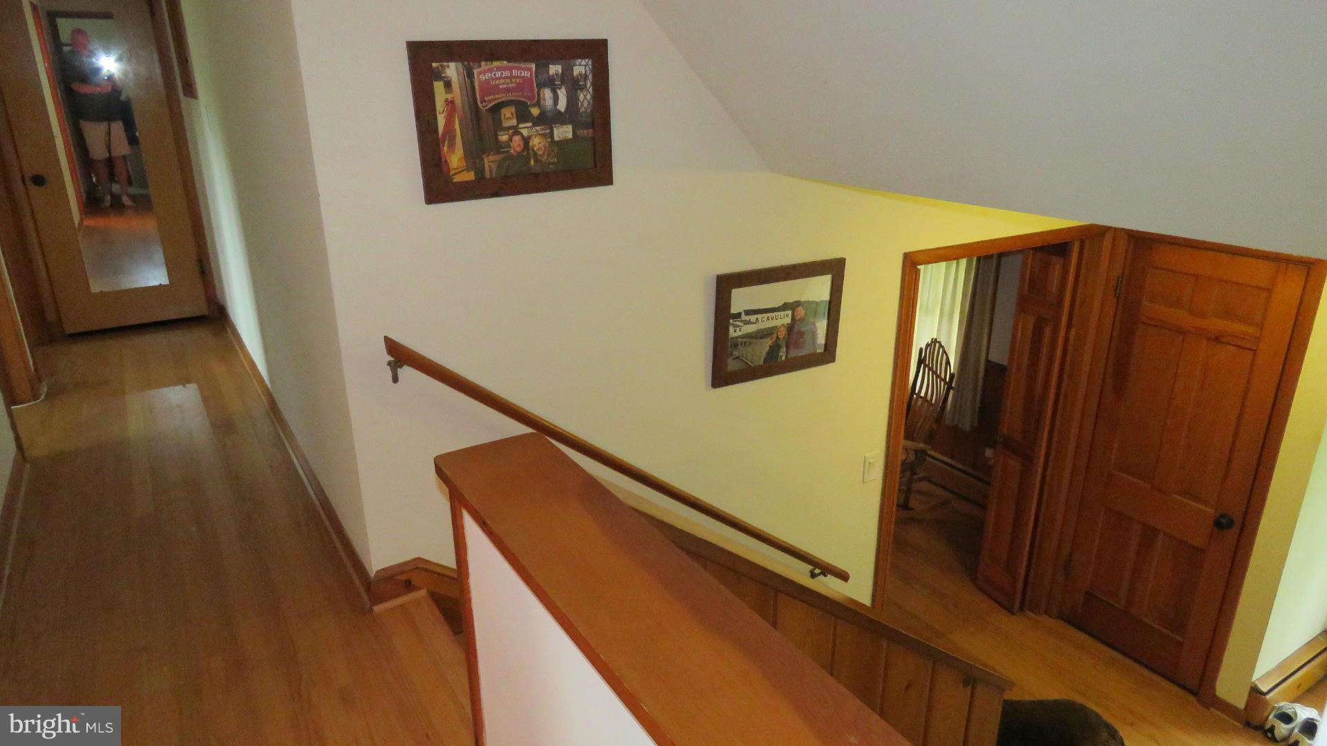 9813 Hawkins Creamery Road Damascus, MD 20872 - Photo 17 of 21 a view of a hallway with wooden floor and stairs