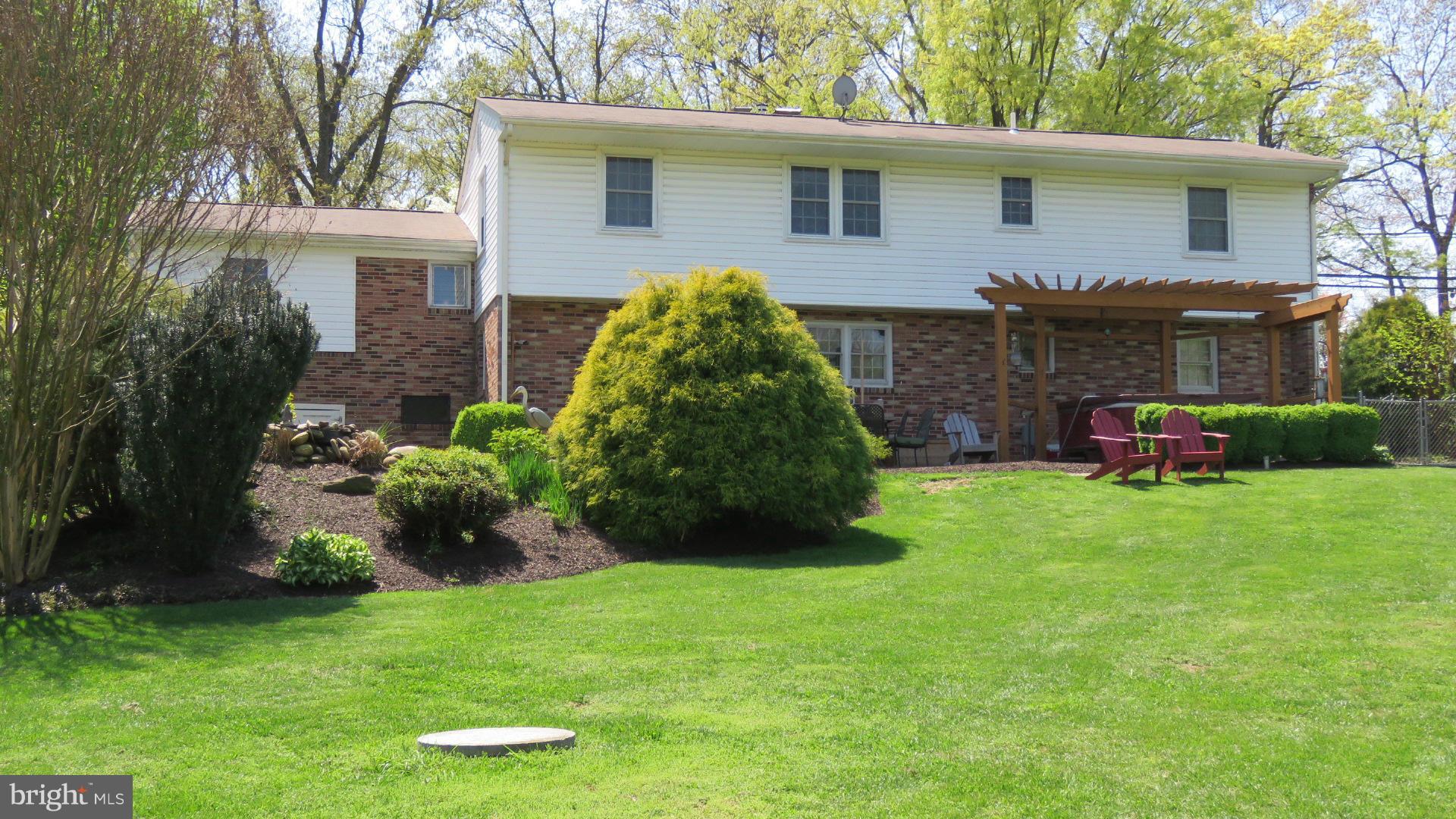 9813 Hawkins Creamery Road Damascus, MD 20872 - Photo 3 of 21 a view of backyard with table and chairs and potted plants and large trees