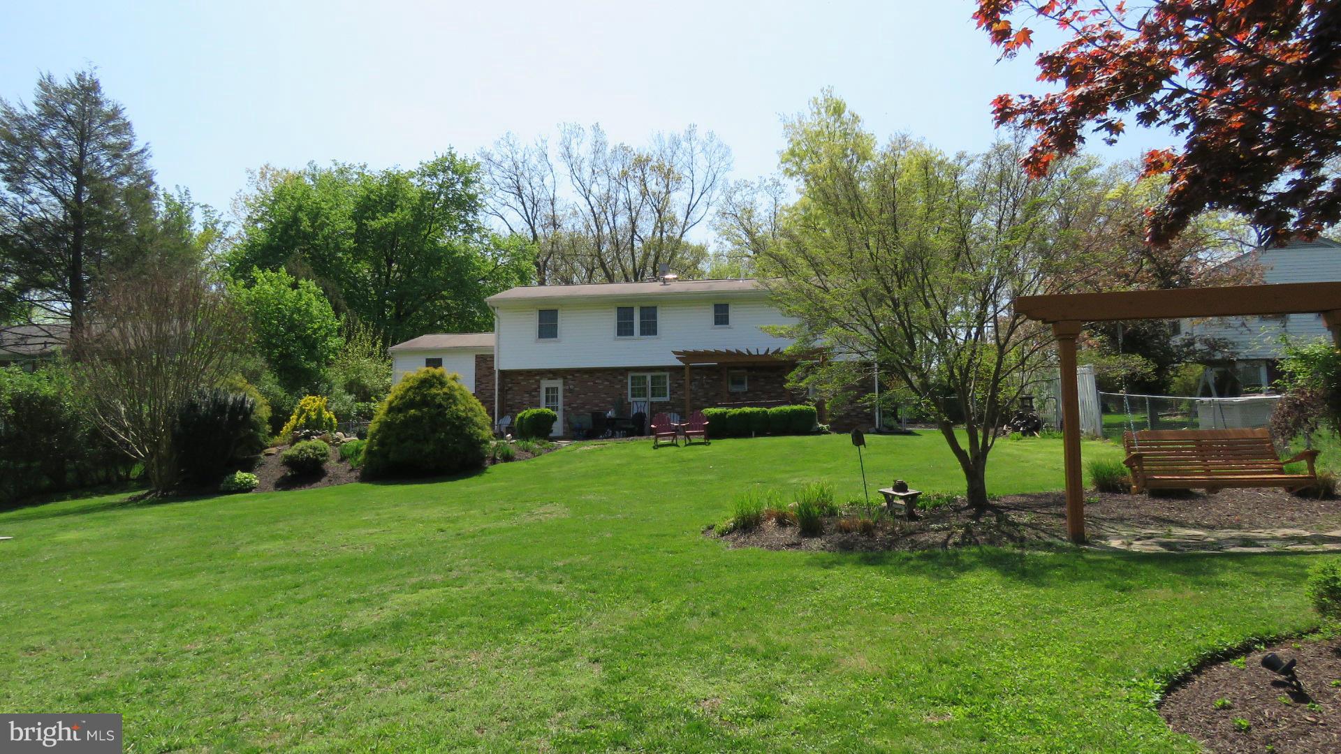 9813 Hawkins Creamery Road Damascus, MD 20872 - Photo 6 of 21 a view of a house with backyard and a sitting area