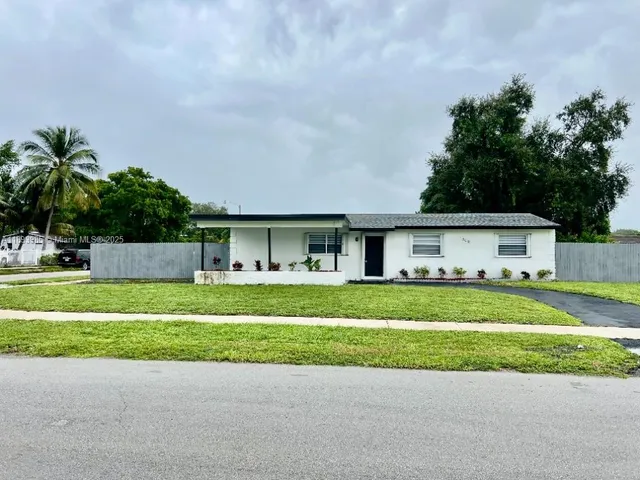 a front view of a house with a yard and a garage