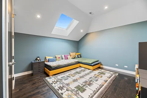 a room with wooden floor and gym equipment