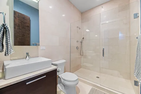 a bathroom with a sink toilet and shower