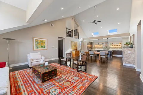 a living room with furniture a table and kitchen view