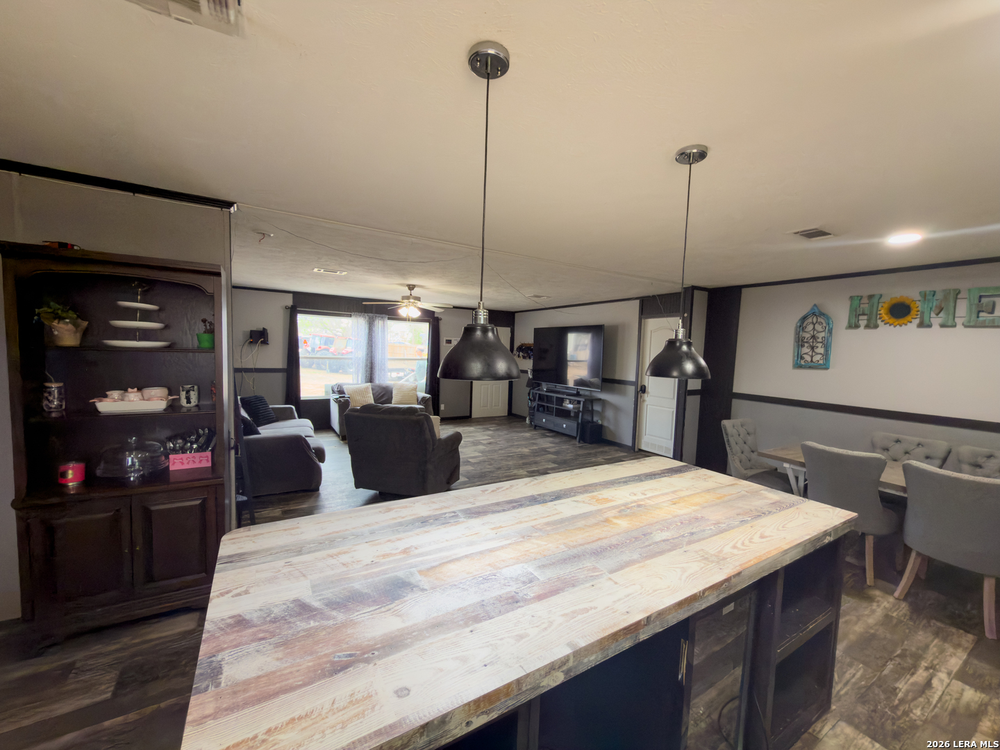 114 4th Street Natalia, TX 78059 - Photo 11 of 32 a large kitchen with kitchen island a counter top space a sink stainless steel appliances and cabinets