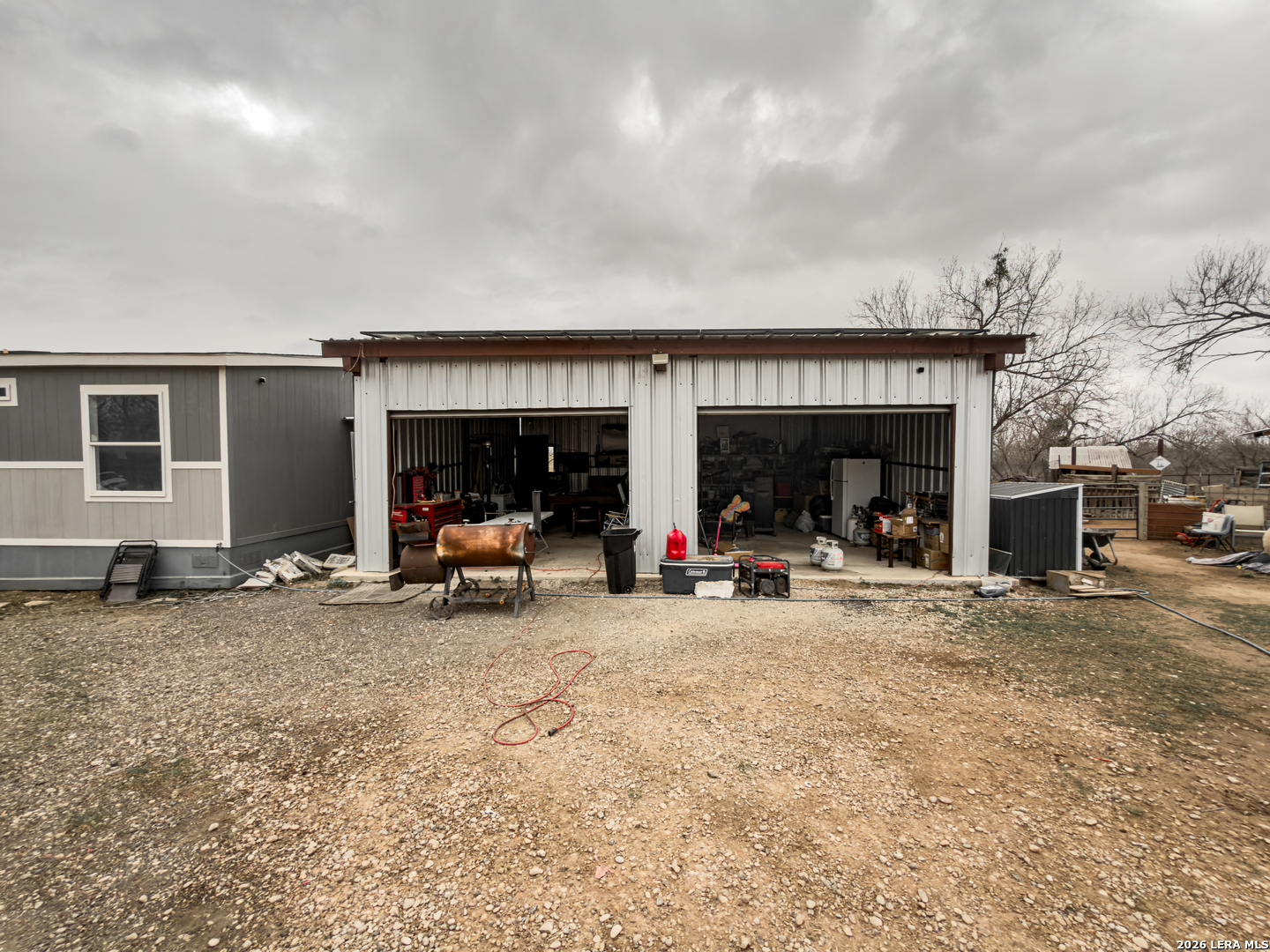 114 4th Street Natalia, TX 78059 - Photo 13 of 32 a view of a house with a patio and a yard