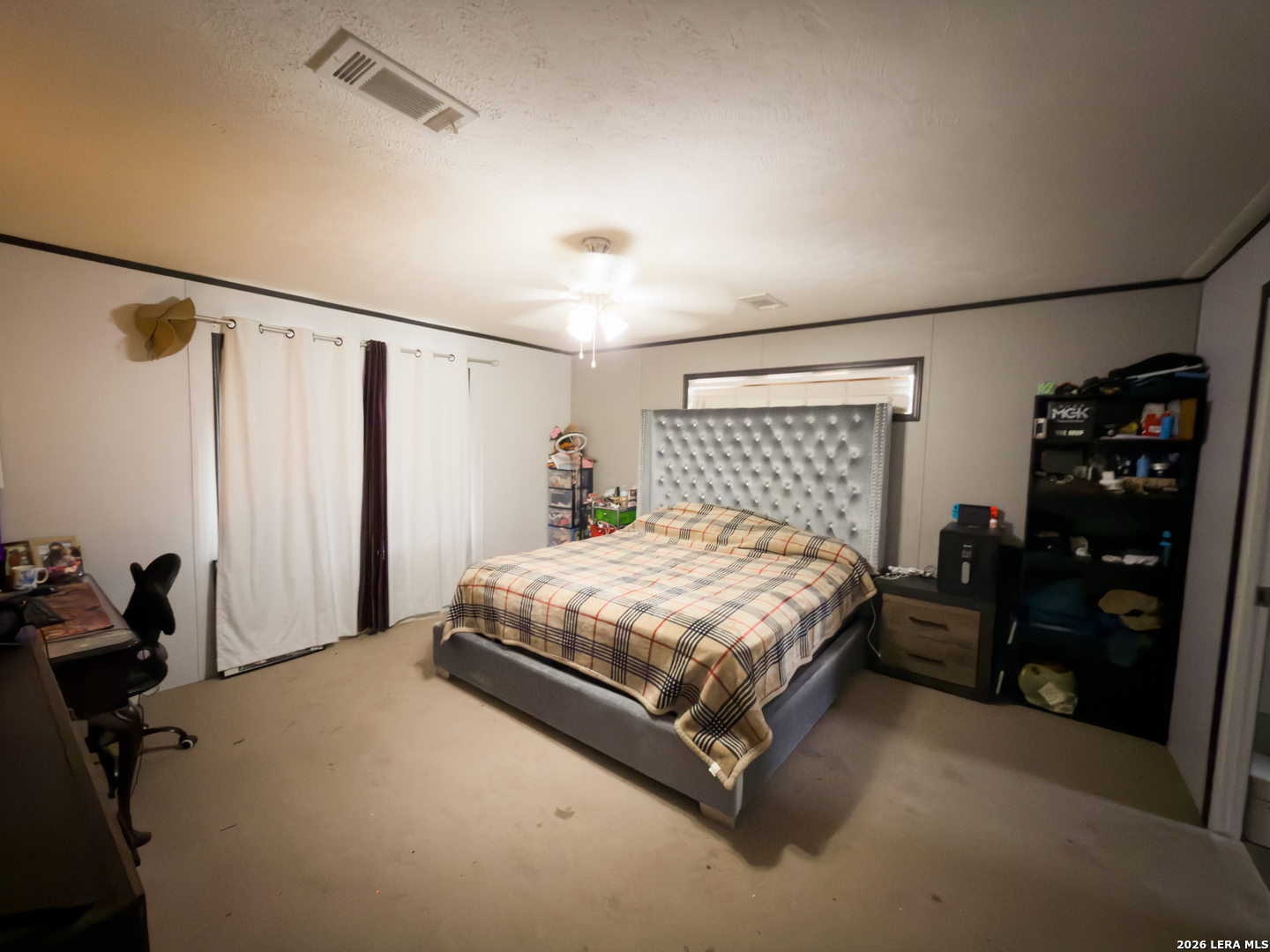 114 4th Street Natalia, TX 78059 - Photo 17 of 32 a bed sitting in a bedroom next to a window