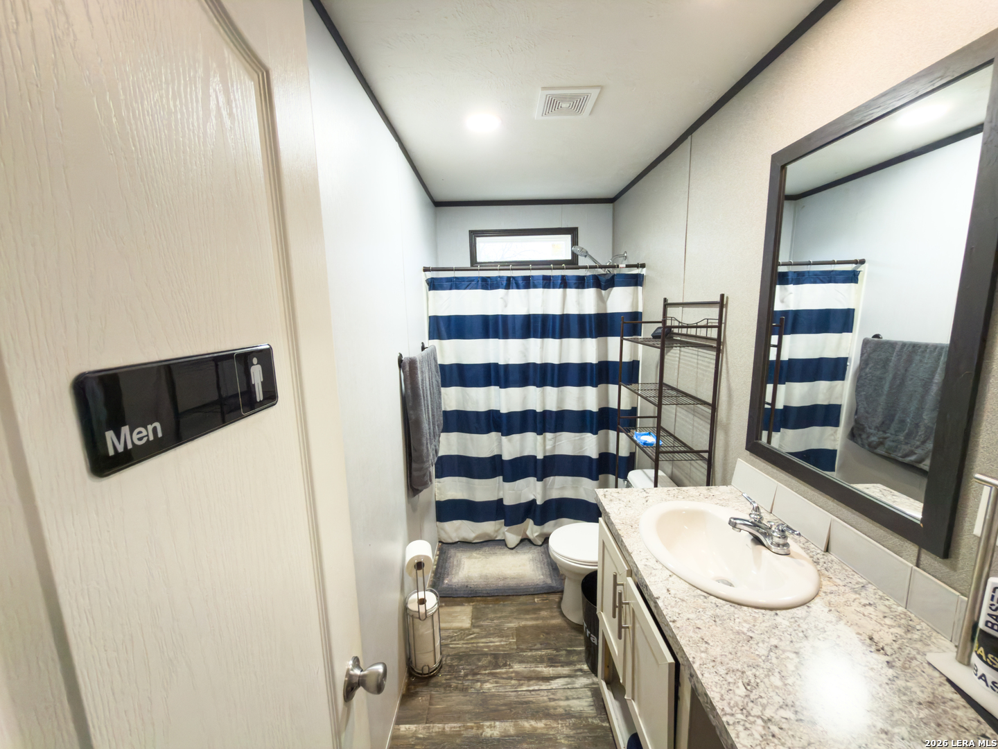 114 4th Street Natalia, TX 78059 - Photo 21 of 32 a bathroom with a sink toilet and shower