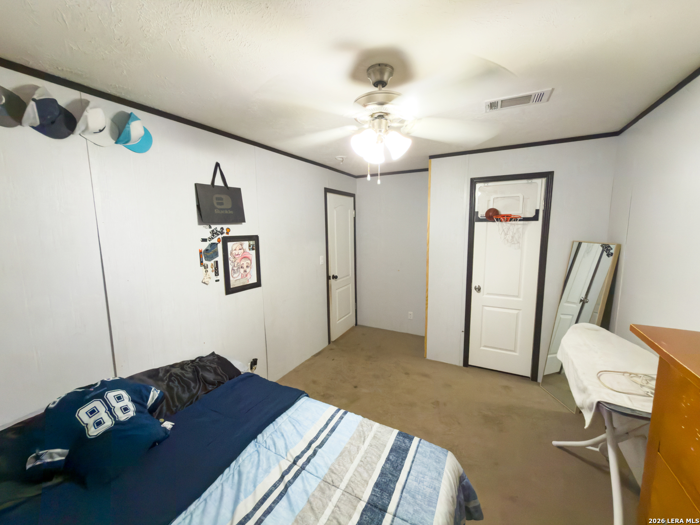 114 4th Street Natalia, TX 78059 - Photo 22 of 32 a bedroom with a bed and a chandelier