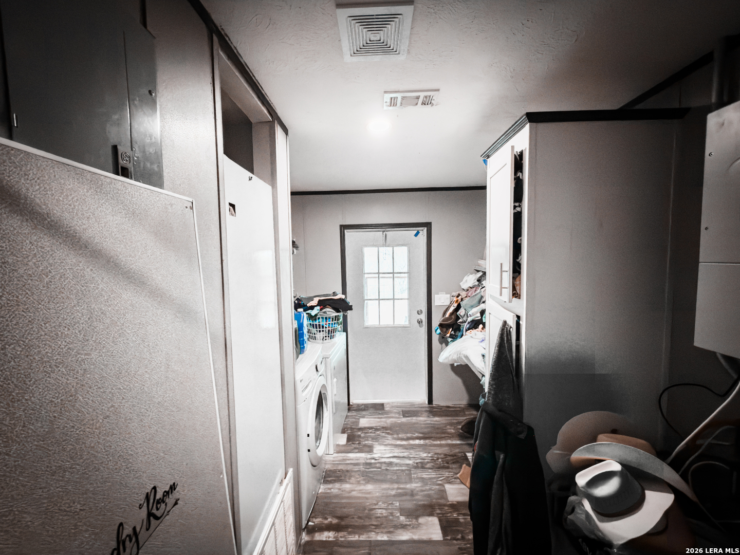 114 4th Street Natalia, TX 78059 - Photo 23 of 32 a view of water heater room with wooden floor