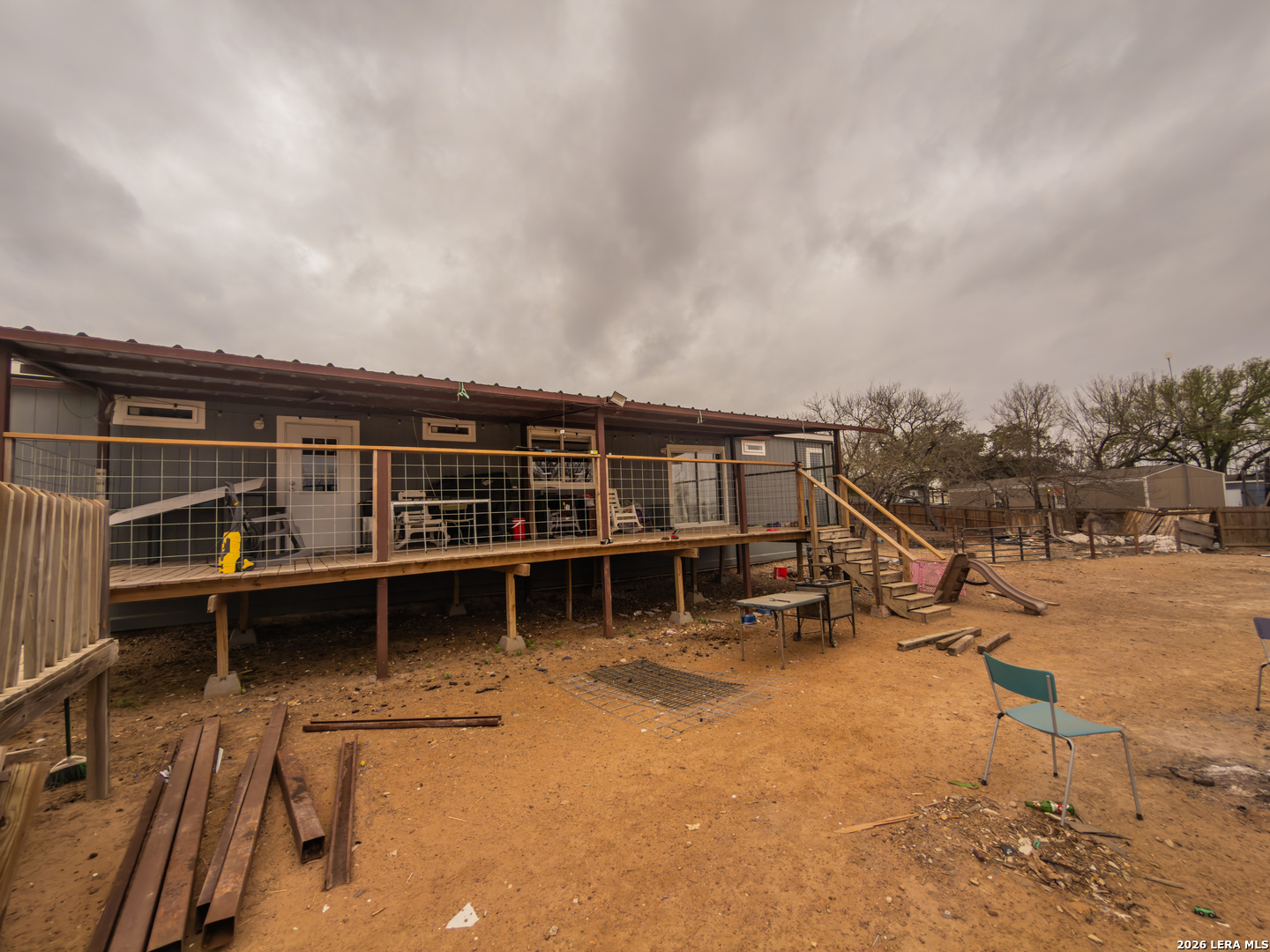 114 4th Street Natalia, TX 78059 - Photo 31 of 32 a view of a house with wooden deck and wooden fence